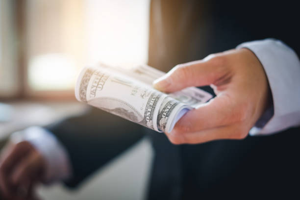 istock Business man holding dollar bills 840166250