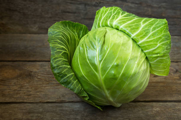 istock Fresh cabbage on an old wooden background 840170018