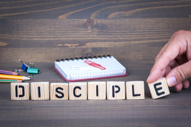 Disciple from wooden letters on wooden background Disciple from wooden letters on wooden background apostle stock pictures, royalty-free photos & images