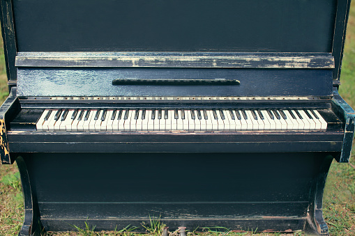 Old vintage piano with broken keys