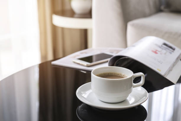 istock Cup of coffee on a round table with sofa in living room 840177160