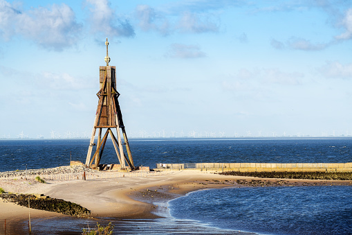Kugelbake, old sea sign and landmark against the blue sky, symbol of the town Cuxhaven on the North Sea in Germany,  popular tourist destination and holiday resort, copy space