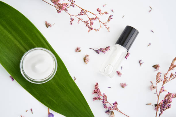 istock White cream bottle placed, Blank label package for mock up on a green foliage background and flowers. The concept of natural beauty products. 840184726