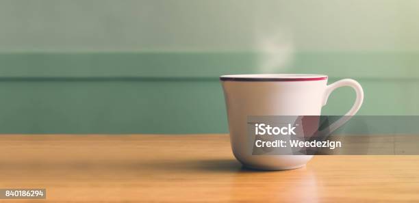 Vintage Filterhot White Coffee Cup On Wood Table With Blur Pastel Green Wall With Sun Light From Right Sideleave Copy Space For Adding Your Text Or Design Stock Photo - Download Image Now