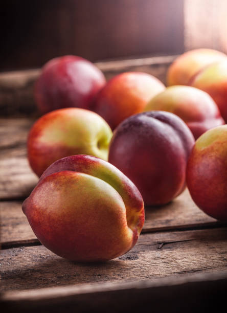 istock Peaches group in wooden box and dark background in studio 840191602