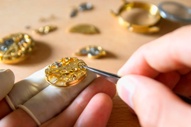istock watch maker is repairing a vintage automatic watch. 840192108