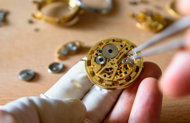 istock watch maker is repairing a vintage automatic watch. 840192184
