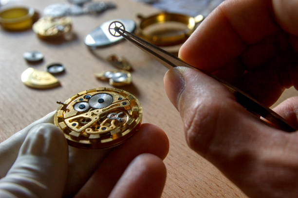 istock watch maker is repairing a vintage automatic watch. 840192330