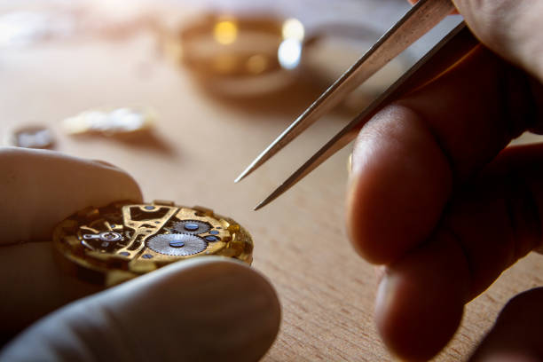 istock watch maker is repairing a vintage automatic watch. 840192336