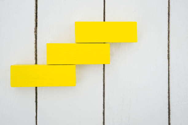 istock Yellow wood block stacking as step stair. Business concept for growth success process. 840198672