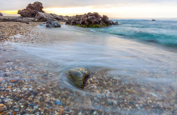 Sunrise at Wilches Beach, Torrox Coast, Malaga, Spain. Visible taro or haze at bottom