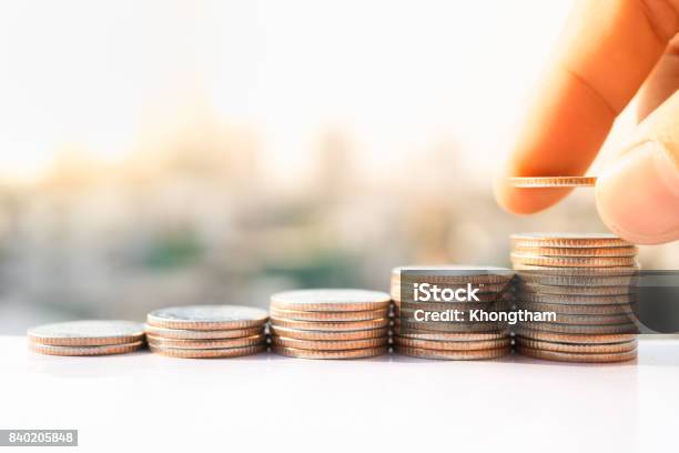 Mans Hand Put Money Coins To Stack Of Coins Money Financial Business Growth Concept Stock Photo - Download Image Now