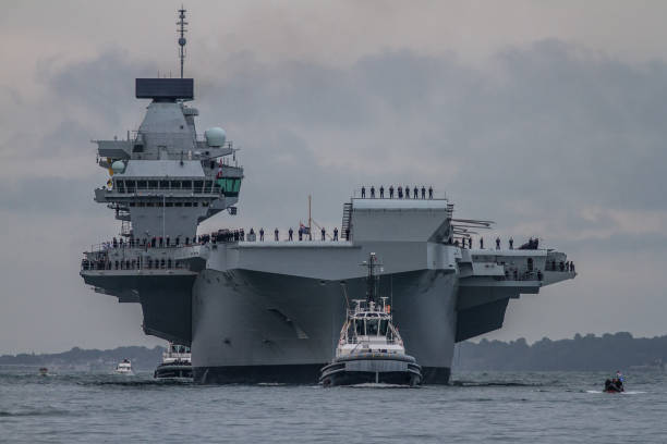 Supercarrier or warship Supercarrier or warship  arrives in Portsmouth for the first time. warship photos stock pictures, royalty-free photos & images