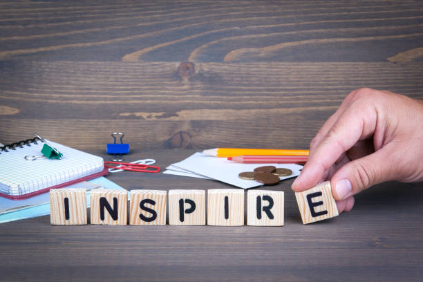 istock Inspire. Wooden letters on dark background 840213118