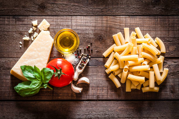 istock Rigatoni pasta with ingredients on rustic wooden table 840216114