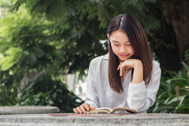 istock Asian woman study book in the park 840223896