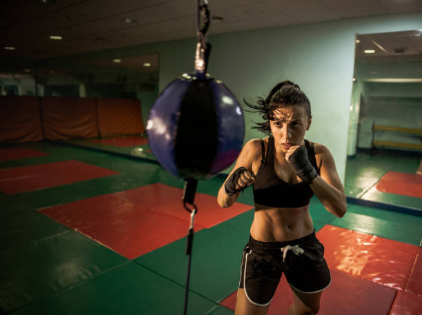 istock fighter girl punching actively 840227150