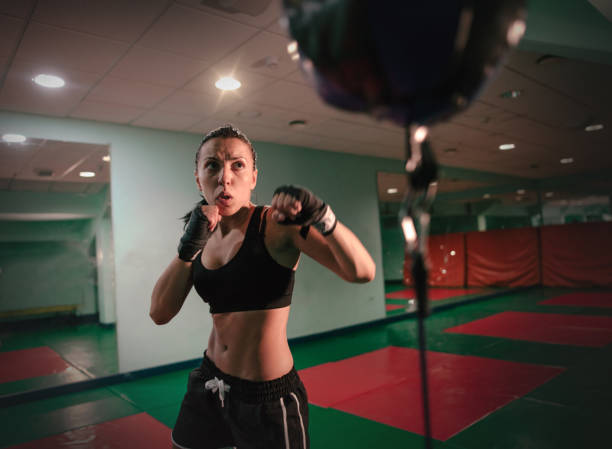 istock fighter girl punching actively 840227160
