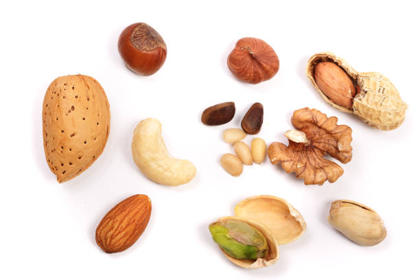 istock mixed of nuts isolated on white background. Almonds, cashews, peanuts, hazelnuts, pine nuts, walnuts 840231106