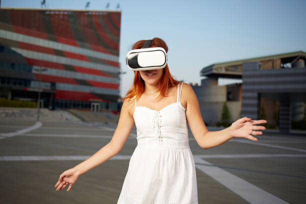 istock Happy woman using virtual reality headset in urban environment 840231166