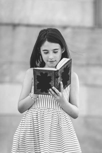 istock Schoolgirl reading a book. 840236094