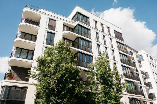 istock modern townhouse apartment building exterior with green tree 840237294