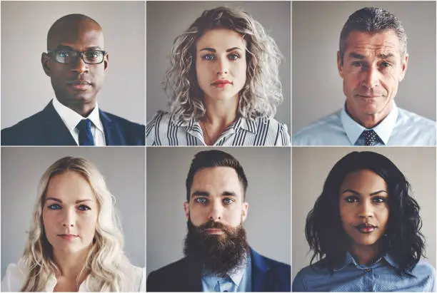 Photo of Ethnically diverse group of focused businessmen and businesswomen