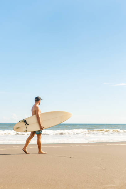 istock Handsome man with surfing board on spot. 840243750