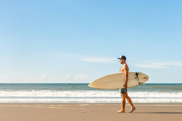 istock Handsome man with surfing board on spot. 840243880