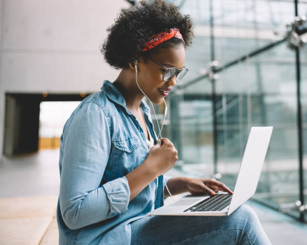istock Young African female student working on a laptop on campus 840244012