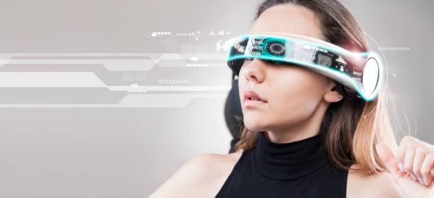 Woman with futuristic smart glasses on grey background