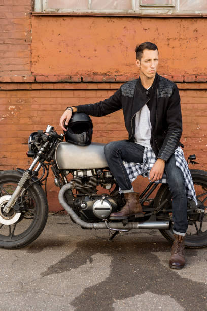 istock Brutal man sit on cafe racer custom motorbike. 840247070