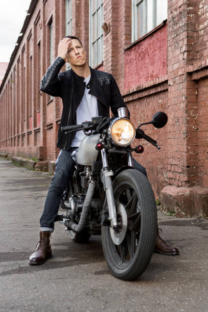 istock Brutal man sit on cafe racer custom motorbike. 840247104