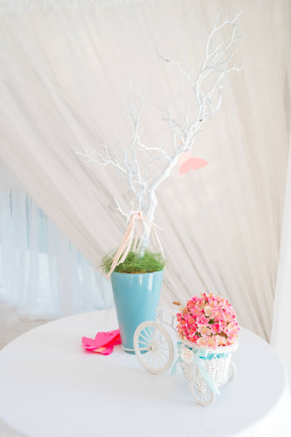 istock Decorative elements on wedding - white branch and decorative little bicycle with basket of flowers. 840247174