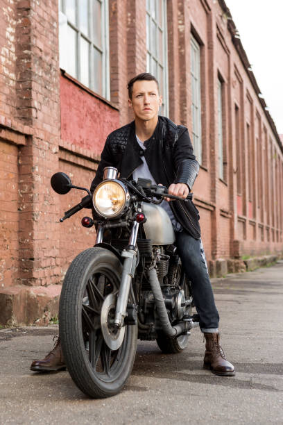 istock Brutal man sit on cafe racer custom motorbike. 840247452