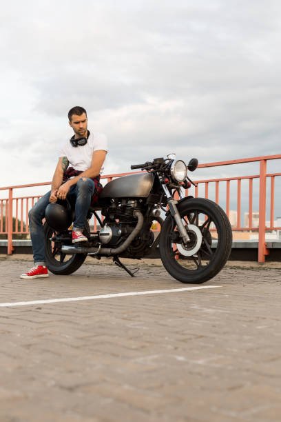 istock Brutal man sit on cafe racer custom motorbike. 840250450