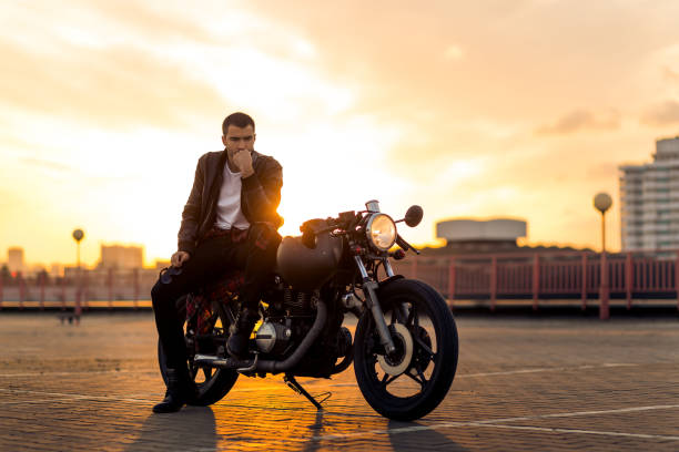 istock Brutal man sit on cafe racer custom motorbike. 840251404