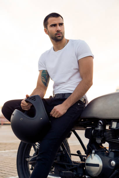 istock Brutal man sit on cafe racer custom motorbike. 840252014