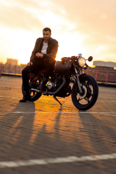 istock Brutal man sit on cafe racer custom motorbike. 840254432