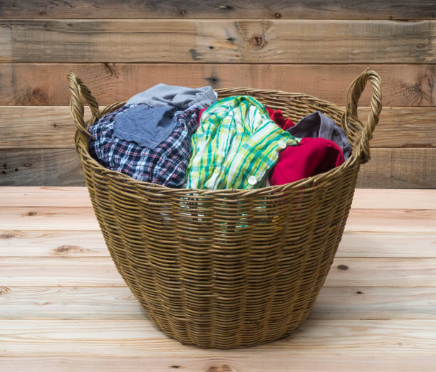 istock Clothes in a laundry wooden basket 840255070