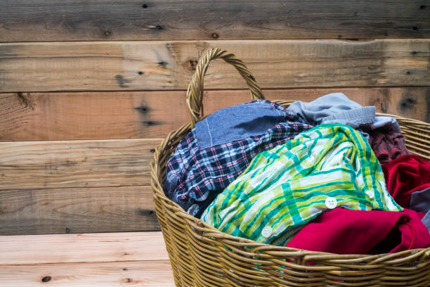 istock Clothes in a laundry wooden basket 840257342
