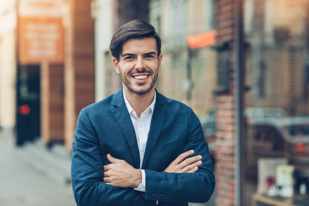 istock Young businessman with arms crossed 840258476