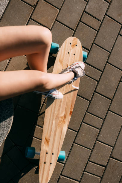 istock Girl with wooden longboard skateboard. 840258540