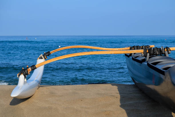 Black Outrigger Hawaiian Outrigger waiting to be launched outrigger stock pictures, royalty-free photos & images