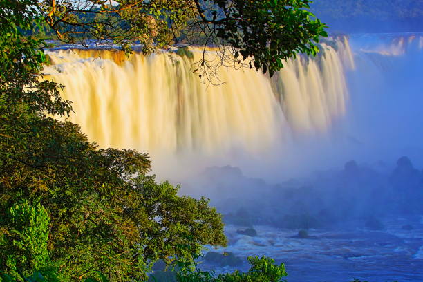 istock Impressive Iguacu falls landscape, blurred motion from long exposure at dramatic sunset - Idyllic Devil's Throat - international border of Brazilian Foz do Iguacu, Parana, Argentina Puerto Iguazu, Misiones and Paraguay - South America 840258668