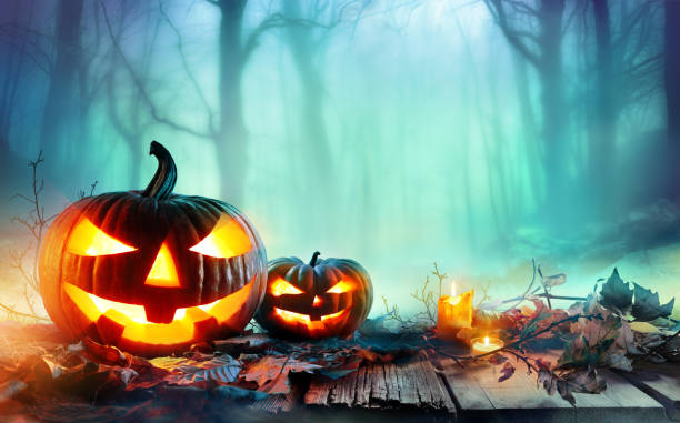 istock Pumpkins Burning In A Spooky Forest At Night - Halloween Background 840261808