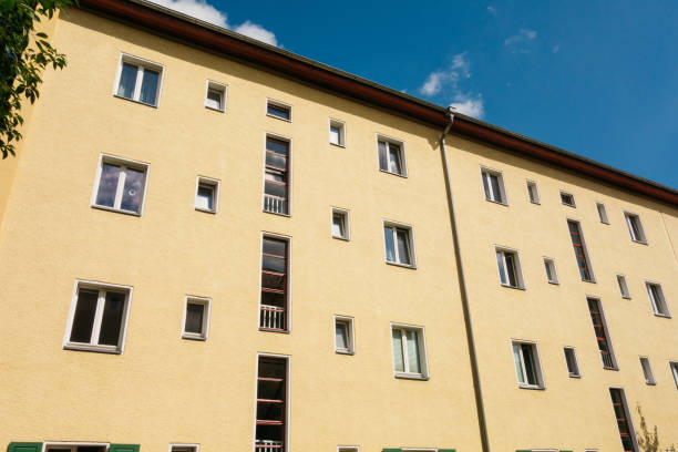 istock yellow apartment house with blue sky 840269492