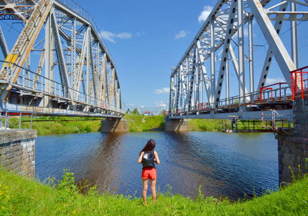 istock Girl by the river between bridges 840272772