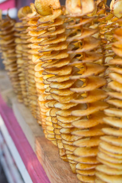 istock Tasty potato chips on a thin wooden stick. Vertical frame. Blurring background 840273260