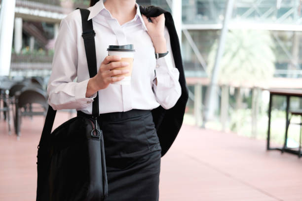 istock Business woman walking drinking coffee. 840273266